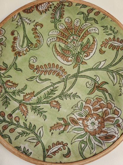 Decorative plate with floral pattern on a green background