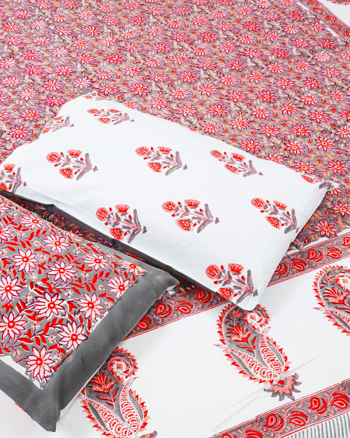 100x108 inch king size cotton bedsheet and matching pillow covers styled with a traditional red floral and grey paisley handblock print.