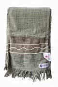 Sage green slub cotton handloom table runner featuring beige braided wave cord details and a fringed hem, with Vasaca brand labels.