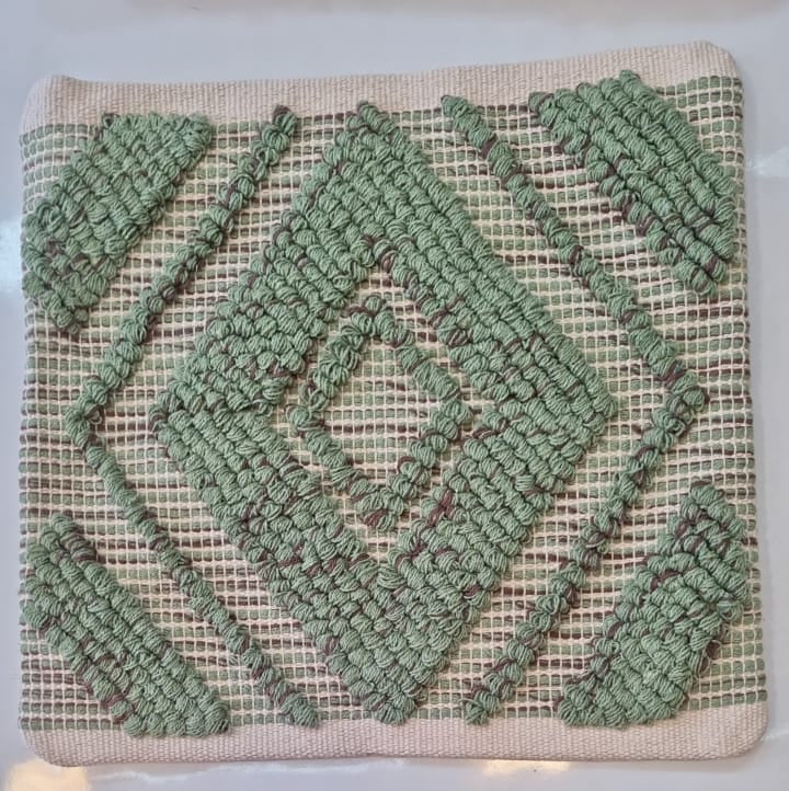 Textile with green and beige geometric pattern on a white background