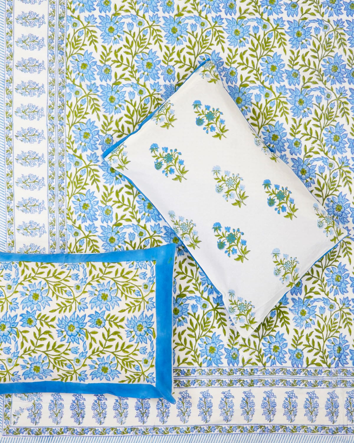 100x108 inch king size cotton bedsheet and matching blue-bordered pillow covers styled with a traditional sky blue and green floral vine handblock print.
