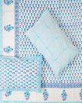 100x108 inch king size cotton bedsheet and matching chevron pillow covers styled with a traditional sky blue and periwinkle floral bud handblock print.