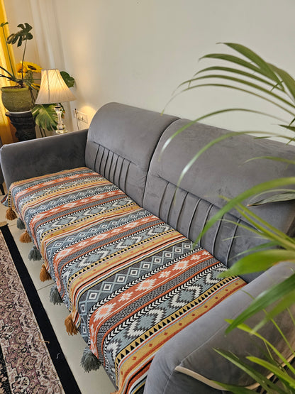 Hanging chair with patterned fabric in a room with plants and a mirror.