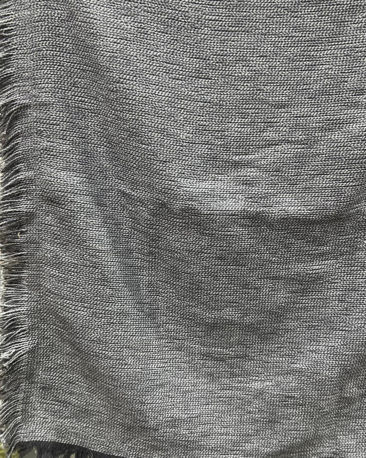 Solid grey handloom cotton table cover featuring a rich textured slub weave and decorative fringe tassels along the edge.