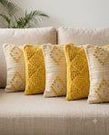 Tant-Tarang 5-piece handloom cotton cushion cover set featuring white tasseled covers and pink and blue pastel frilled covers styled on a sofa.