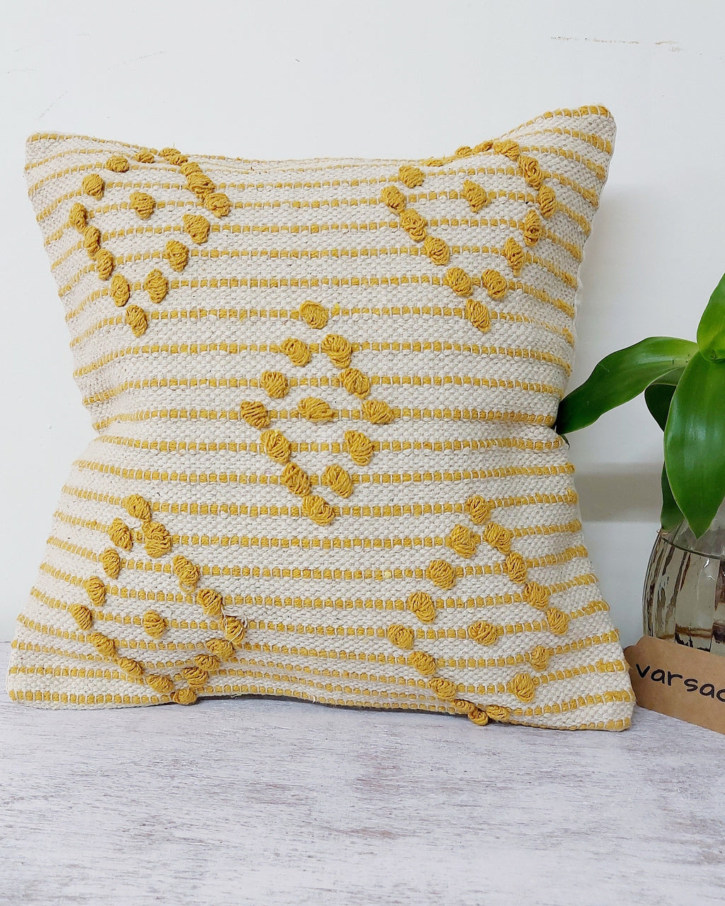 Tant-Tarang 5-piece handloom cotton cushion cover set featuring white tasseled covers and pink and blue pastel frilled covers styled on a sofa.