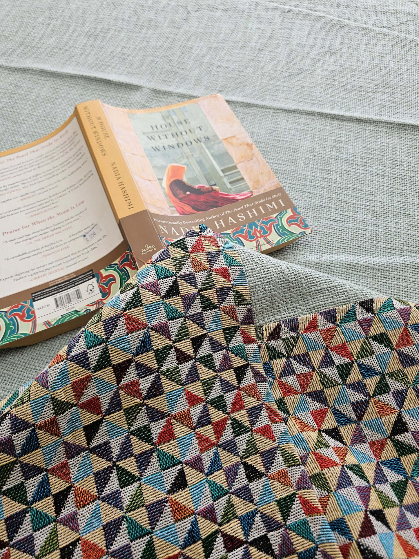 Book with a colorful geometric patterned cover on a textured surface