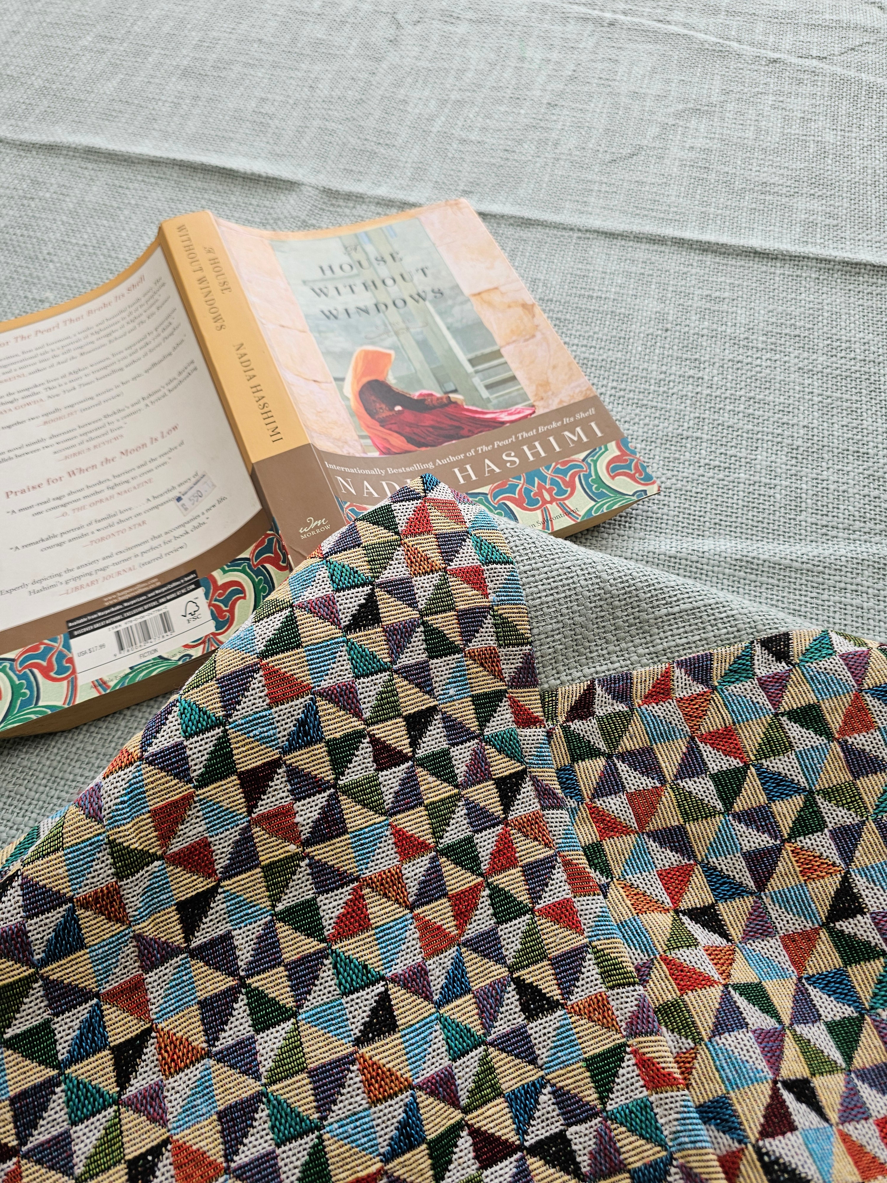 Book with a colorful geometric patterned cover on a textured surface