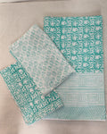 Folded 100x108 inch king size cotton bedsheet and matching pillow covers featuring a traditional teal and white handblock floral print.