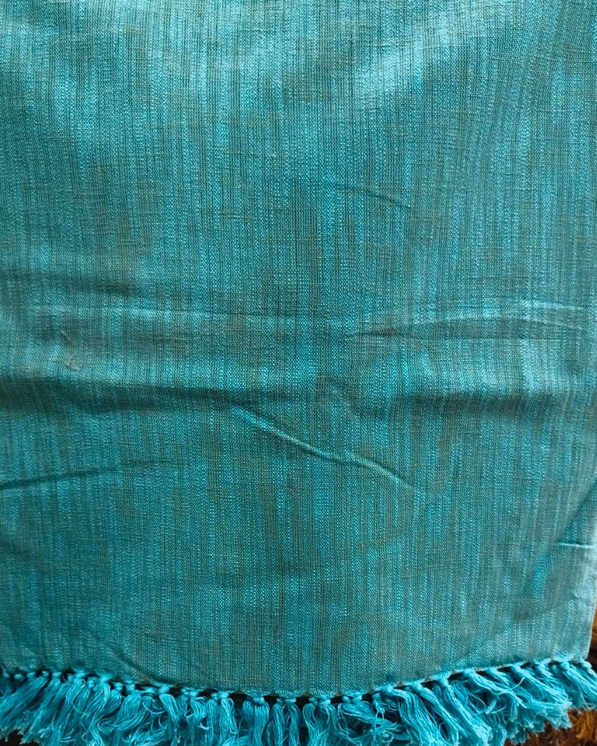 Teal handloom slub cotton king size bed cover featuring a textured solid weave and handcrafted fringe tassels.