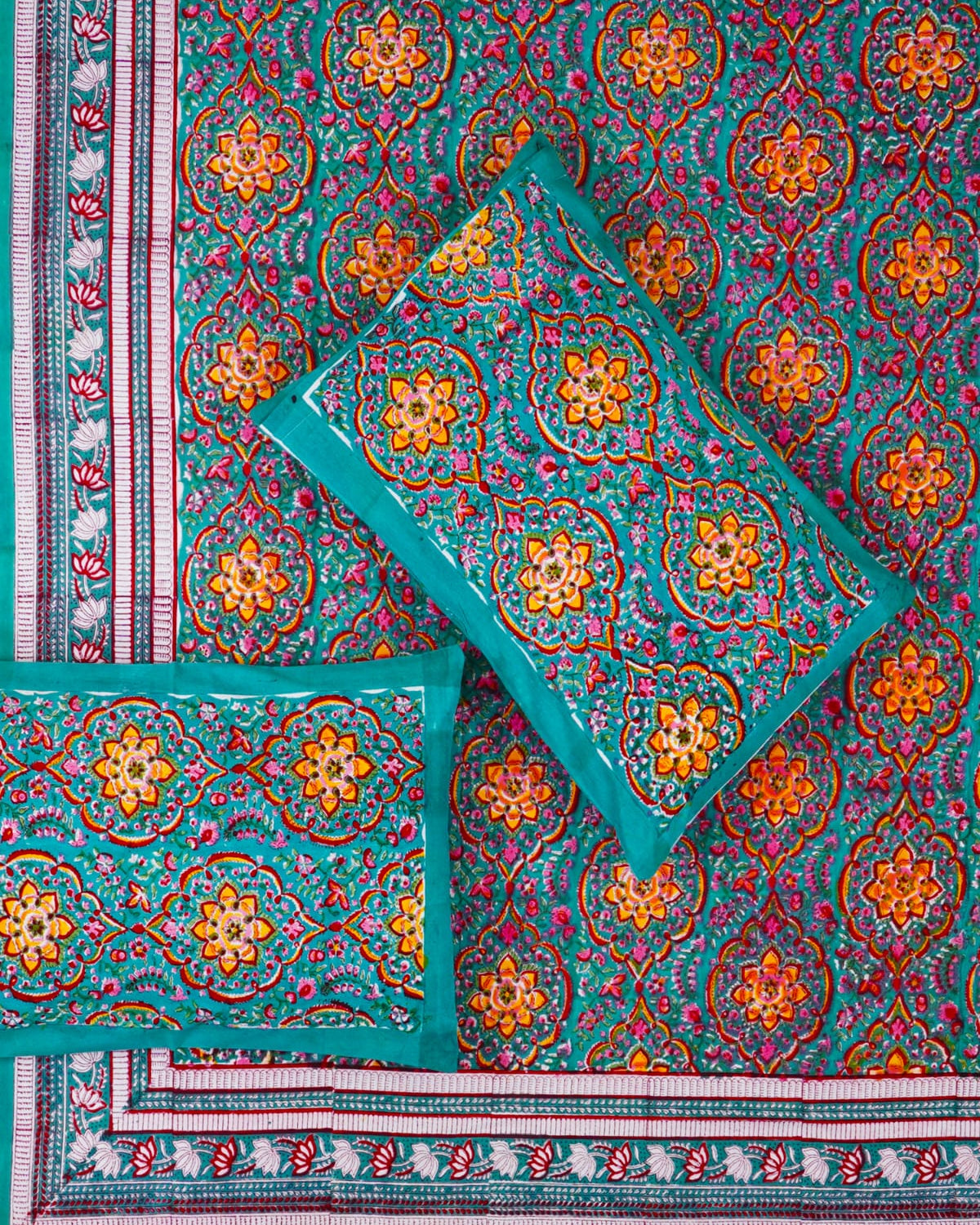 100x108 inch king size cotton bedsheet and matching pillow covers styled with a traditional teal, orange, and pink medallion handblock print.