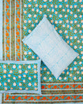 100x108 inch king size cotton bedsheet and matching pillow covers styled with a traditional turquoise blue and vibrant orange handblock floral print.