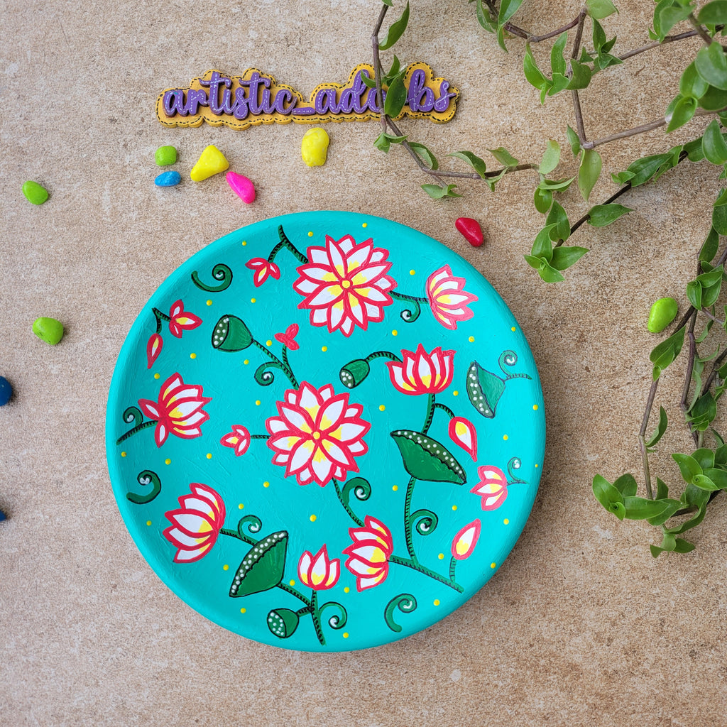 Turquoise terracotta wall plate hand-painted with a traditional Rajasthani Pichwai pink lotus pond design.