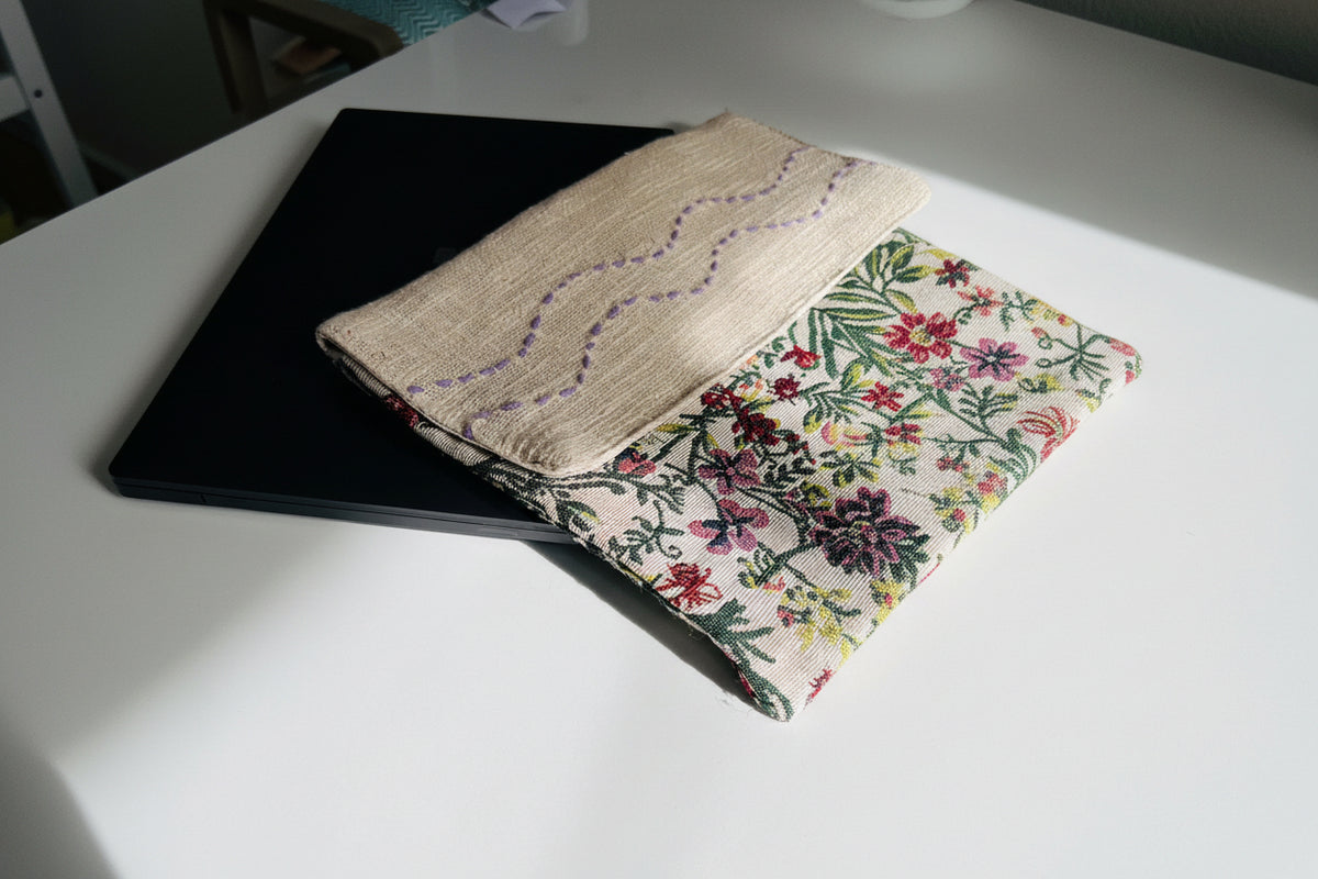 Wildflower Tapestry Jute Cotton Laptop Sleeve featuring botanical woven tapestry fabric and natural jute with purple hand-stitched wave embroidery