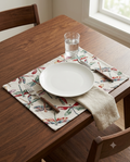 Rectangular woven cotton table placemat with a colorful red, green, and yellow dragonfly motif on an off-white cream background.