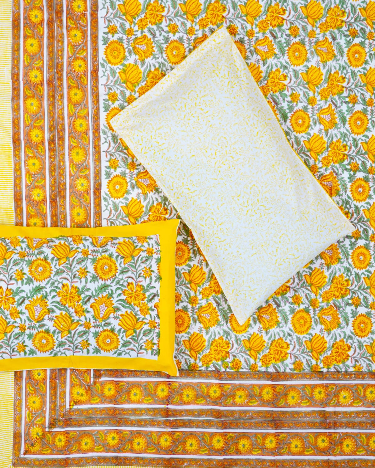 100x108 inch king size cotton bedsheet and matching pillow covers styled with a traditional yellow and green handblock floral print.
